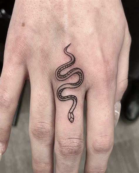 middle finger tattoo|snake tattoo on middle finger.